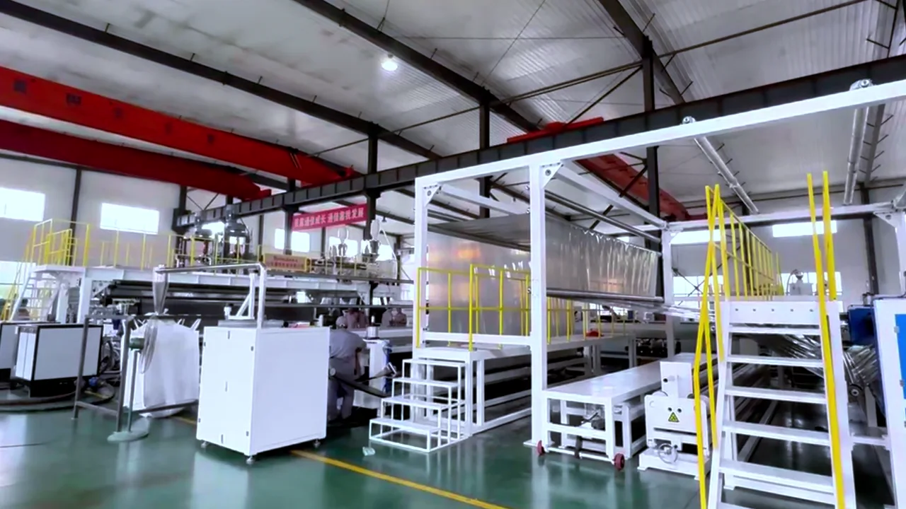 Wide overview of geomembrane production-line equipment in a workshop